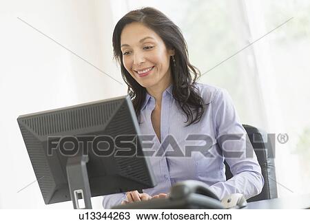 Business woman working on computer View Large Photo Image Stock Image - Business woman working on computer. Fotosearch