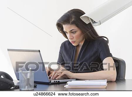 Picture - Businesswoman spied on by cctv camera. Fotosearch