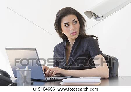 Stock Photograph - Businesswoman spied on by cctv camera. Fotosearch