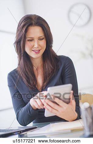 Businesswoman using digital tablet View Large Photo Image Stock Image - Businesswoman using digital tablet. Fotosearch