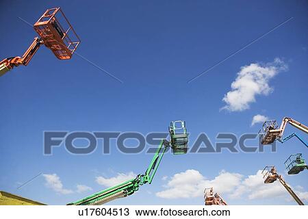 Stock Image - Cherry pickers on construction site. Fotosearch