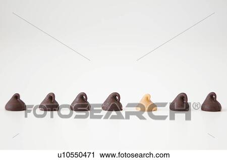 Stock Image - Chocolate sweets on white background, studio shot. Fotosearch