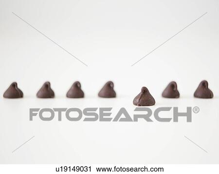 Stock Image - Chocolate sweets on white background, studio shot. Fotosearch