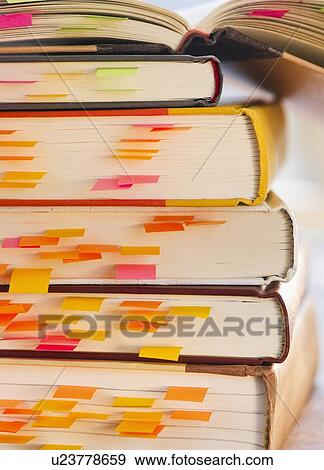 Close up adhesive notes in books, studio shot View Large Photo Image Stock Photo - Close up adhesive notes in books, studio shot. Fotosearch