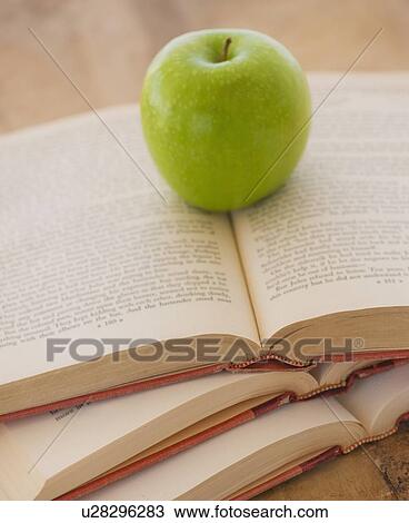 Close up of apple on open books, studio shot View Large Photo Image Stock Image - Close up of apple on open books, studio shot. Fotosearch