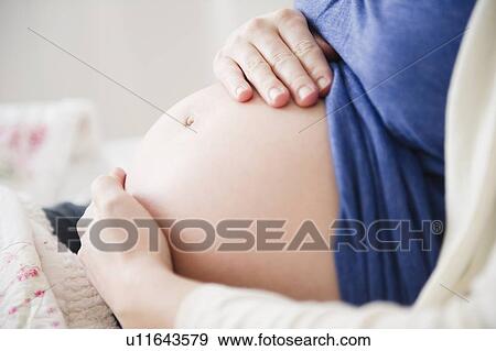 Stock Photo - Close-up of belly of pregnant woman . Fotosearch