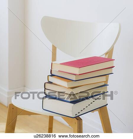 Stock Photograph - Close up of book on a chair, studio shot. Fotosearch