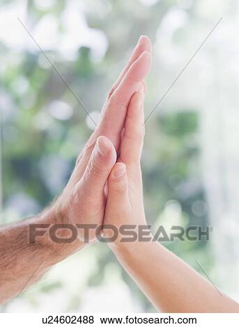 Close up of father's and son's (10-11 years) hands doing high five View Large Photo Image Stock Photo - Close up of father's and son's (10-11 years) hands doing high five. Fotosearch