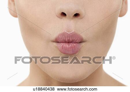 Stock Photo - Close-up of female lips blowing kiss. Fotosearch