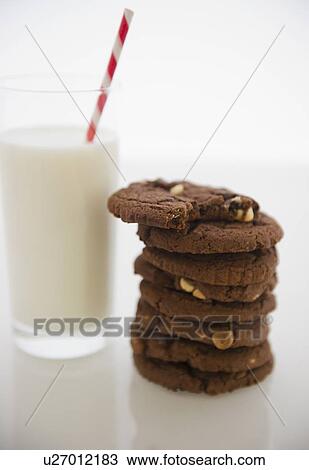 Close up of glass of milk and chocolate cookies View Large Photo Image Stock Image - Close up of glass of milk and chocolate cookies. Fotosearch