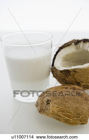 Close up of glass of milk and coconut fruit View Large Photo Image Picture - Close up of glass of milk and coconut fruit. Fotosearch