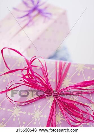 Stock Image - Close up of ribbon on birthday present, studio shot. Fotosearch