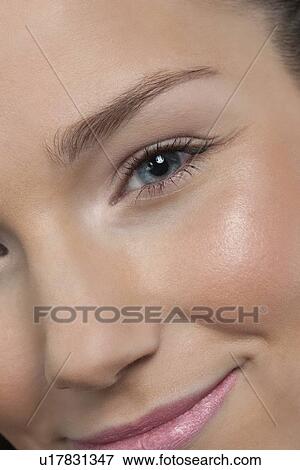 Close-up of smiling female face View Large Photo Image Stock Photo - Close-up of smiling female face. Fotosearch