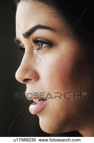 Stock Photography - Close-up of young woman crying. Fotosearch