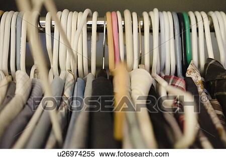 Coat hangers with clothing View Large Photo Image Stock Photography - Coat hangers with clothing. Fotosearch
