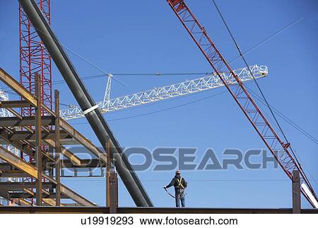Stock Image - Construction worker on construction frame. Fotosearch