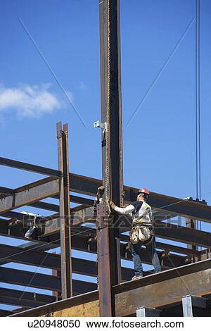 Construction worker on construction frame View Large Photo Image Stock Image - Construction worker on construction frame. Fotosearch