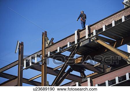 Construction worker on construction frame View Large Photo Image Stock Image - Construction worker on construction frame. Fotosearch