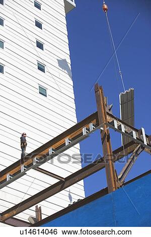 Construction worker on construction frame View Large Photo Image Stock Photograph - Construction worker on construction frame. Fotosearch