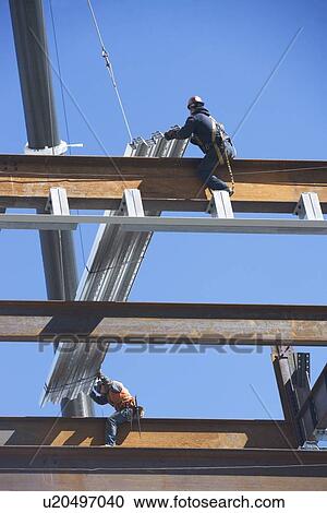 Construction workers on construction frame View Large Photo Image Stock Image - Construction workers on construction frame. Fotosearch