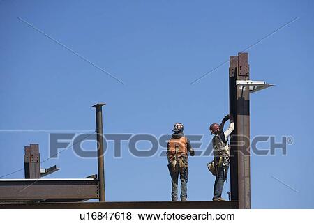 Construction workers on construction frame View Large Photo Image Stock Photo - Construction workers on construction frame. Fotosearch