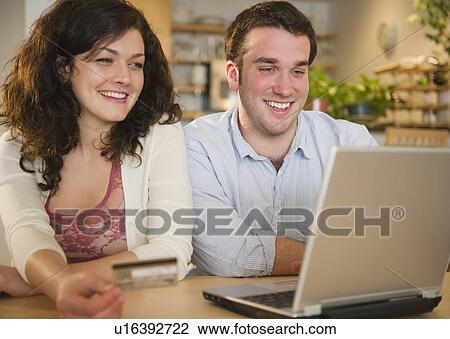 Stock Image - Couple online shopping. Fotosearch