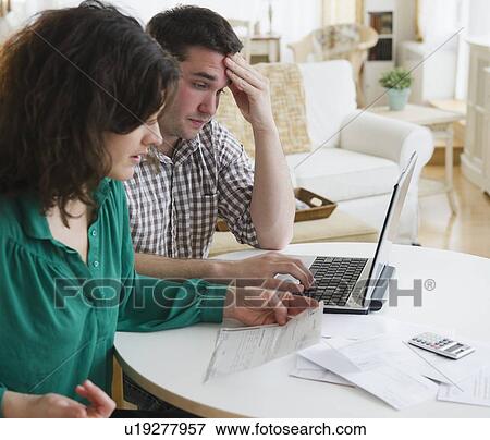 Couple paying bills via internet View Large Photo Image Stock Photo - Couple paying bills via internet. Fotosearch