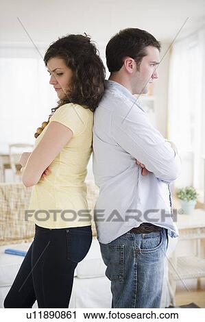 Couple standing back to back View Large Photo Image Stock Image - Couple standing back to back. Fotosearch