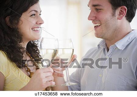 Couple toasting with wine View Large Photo Image Stock Photo - Couple toasting with wine. Fotosearch