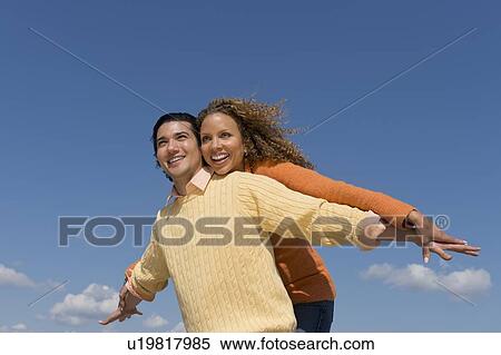Stock Photography - Couple under blue sky. Fotosearch