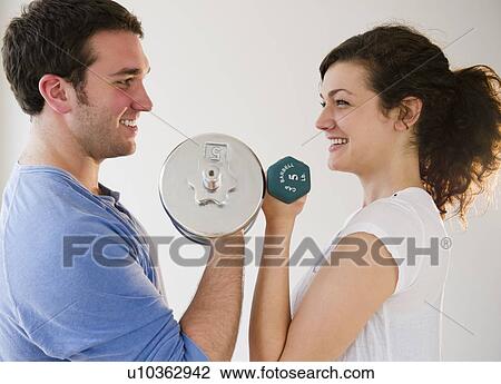 Stock Image - Couple weightlifting. Fotosearch