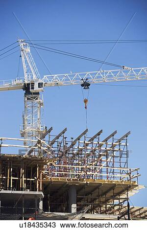 Stock Image - Crane on construction site. Fotosearch