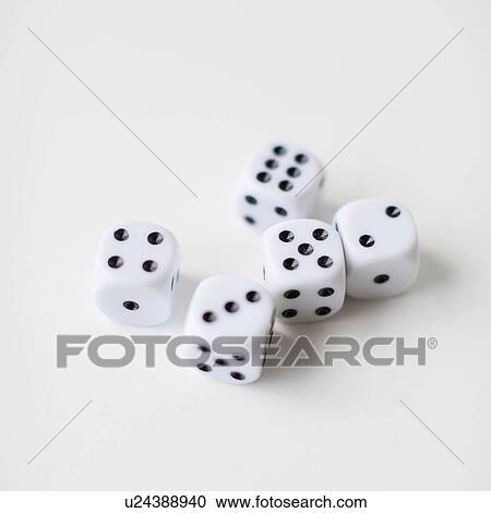 Stock Image - Dices on white background, studio shot. Fotosearch