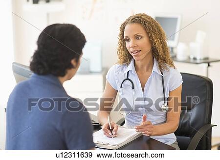 Doctor and patient talking in clinic View Large Photo Image Stock Photo - Doctor and patient talking in clinic. Fotosearch