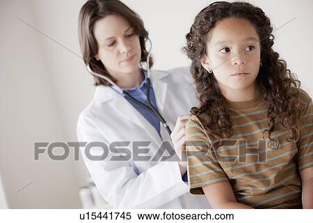 Doctor examining girl (8-9) View Large Photo Image Stock Photography - Doctor examining girl (8-9). Fotosearch