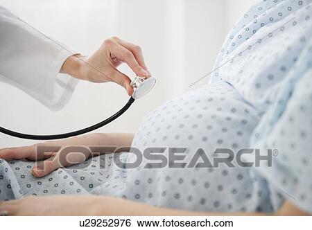 Doctor examining pregnant woman View Large Photo Image Stock Photograph - Doctor examining pregnant woman . Fotosearch