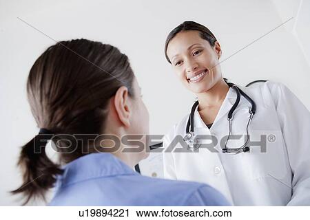 Doctor talking with patient View Large Photo Image Stock Image - Doctor talking with patient. Fotosearch