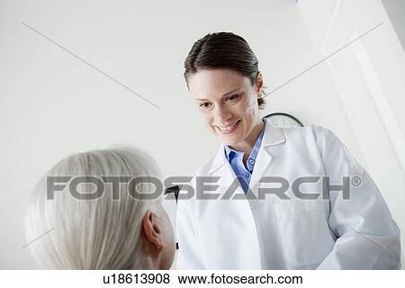 Doctor talking with senior patient View Large Photo Image Stock Photo - Doctor talking with senior patient. Fotosearch