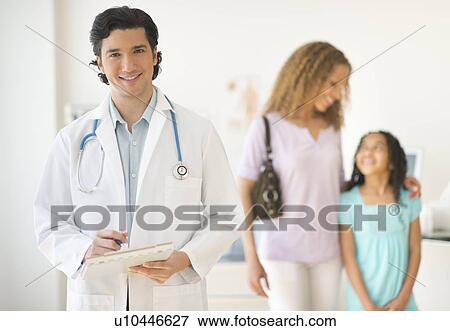 Doctor with patients (woman and girl aged 12-13) in office View Large Photo Image Stock Photo - Doctor with patients (woman and girl aged 12-13) in office. Fotosearch