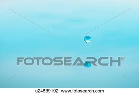 Stock Image - Drop falling into water. Fotosearch