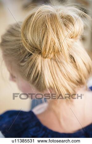 Stock Image - Elevated view of woman with hair bun. Fotosearch
