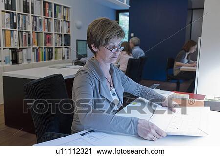 Stock Image - Employees of design agency at work. Fotosearch