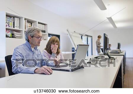 Stock Image - Employees of design agency at work. Fotosearch
