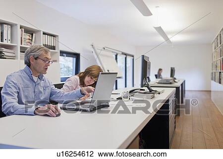 Stock Image - Employees of design agency at work. Fotosearch
