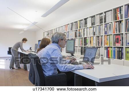 Stock Image - Employees of design agency at work. Fotosearch