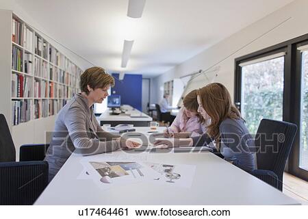 Stock Image - Employees of design agency at work. Fotosearch
