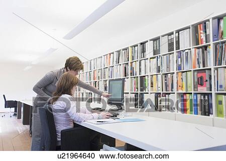 Stock Image - Employees of design agency at work. Fotosearch