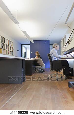 Stock Photo - Employees of design agency at work. Fotosearch