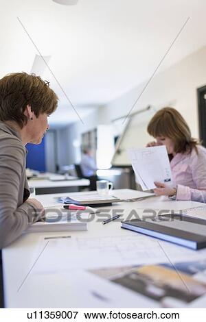Stock Photo - Employees of design agency at work. Fotosearch