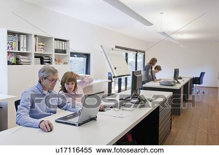 Stock Photography - Employees of design agency at work. Fotosearch